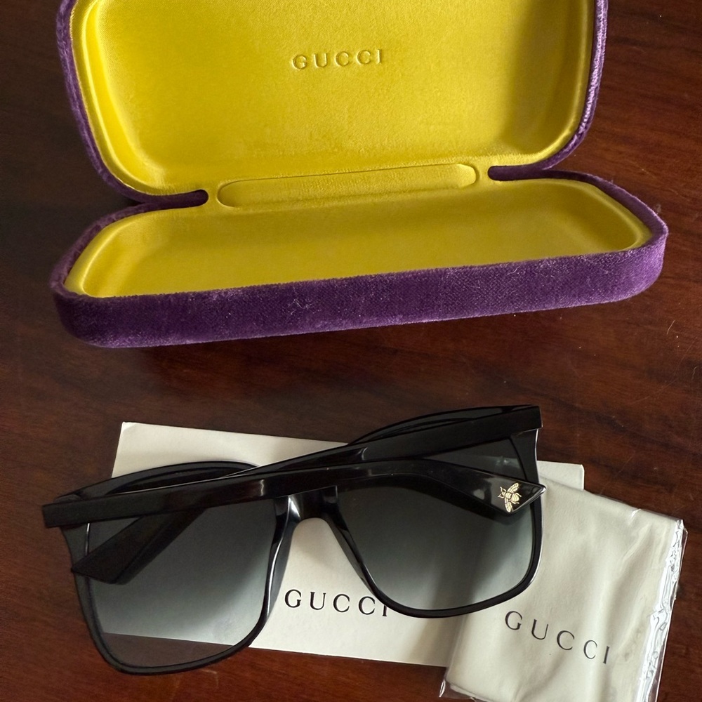 Gucci sunglasses I got for Christmas. They are too big for my face. Never worn.